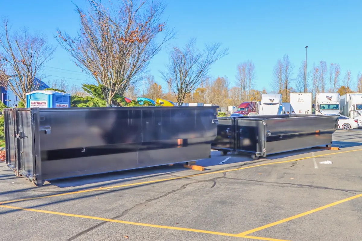 Professional dumpster rental service with roll-off container on residential driveway in Boiling Spring Lakes